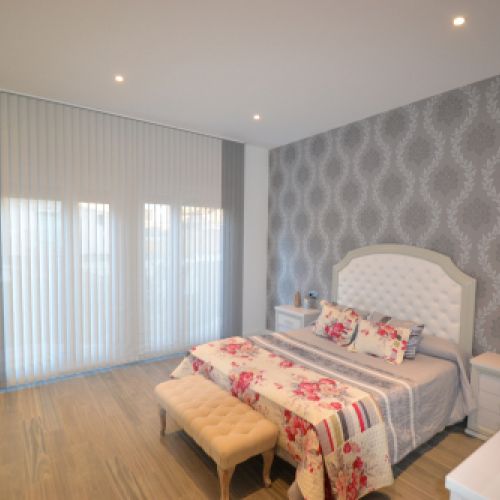 Cortina Vertical Bandalux combinada en dos colores en un dormitorio